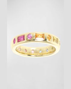 a yellow gold ring with different colored stones