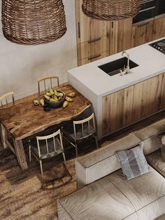 an overhead view of a kitchen and living room area with couches, chairs, table and sink