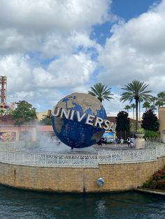 the universal sign is surrounded by water and palm trees