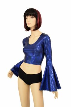 "This item is made to order, please read all the way through the listing before purchasing! This shiny, sparkling holographic top is made of spandex in a beautiful blue sparkly jewel holographic. It features a scoop neckline in front and Trumpet sleeves. Four way stretch spandex for a great fit! TOP LENGTH: Underarm to hemline measures 8\" Womens Sizing (See below for instructions on where measurements should be taken) XXS: Bust 29\"-30\" / Waist 22\"-23\" / Hips 30\"-32\" Extra Small: Bust 31\" Fitted Metallic Shiny Crop Top, Metallic Shiny Fitted Crop Top, Fitted Iridescent Tops, Fitted Metallic Glamorous Crop Top, Disco Shimmer Tops, Metallic Fitted Disco Crop Top, Fitted Metallic Shiny Tops, Metallic Shiny Fitted Tops, Metallic Stretch Disco Top