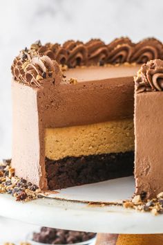 a chocolate cake with one slice cut out and the other half eaten on a plate