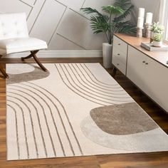 a living room with a white chair and rug