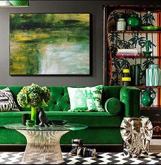 a living room filled with green furniture and decor