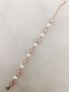 Our favorite UP classic style. Stunning crystal and pearl detailed bracelet in Gold, Silver and Rose Gold. Made with 18K Gold Plated/925 Silver Based Metal Details measure 6 inches with a 2 inch adjustable chain. READY TO SHIP - Ships in 1 to 3 business days Elegant Rose Gold Crystal Bracelets, Elegant Rose Gold Cubic Zirconia Crystal Bracelet, Elegant Bracelet With Sparkling Stones, Elegant Pearl Bracelet For Party, Elegant Crystal Bracelet With Sparkling Stones, Elegant Crystal Diamond Bracelet With Sparkling Stones, Elegant Crystal Charm Bracelet, Elegant Diamond Bracelet With Sparkling Stones, Elegant Pearl Drop Bracelet For Party