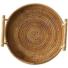 a round wicker basket with two wooden handles