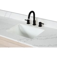 a white sink with black faucet and marble counter top