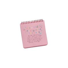 a pink spiral notebook with writing on it