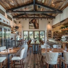 the inside of a restaurant with wooden tables and chairs