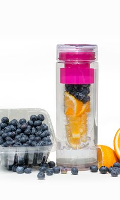 blueberries, oranges and other fruits are in plastic containers next to each other