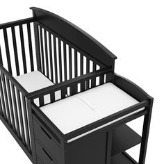 a black crib with two drawers and a white sheet on the bottom shelf next to it