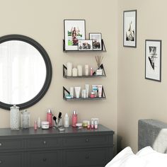 a bedroom with a mirror, dresser and shelves filled with personal care products on it