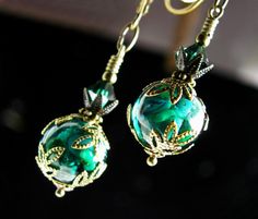 Peacock Green Victorian Earrings Gothic Blue Green Glass Drop Teal Edwardian Bridal Steampunk  Antique Gold Bronze Titanic Temptations "Encapsulated Coral Reef" 1 Pair of Victorian Style Earrings Handmade, Free Style Design   Blue Green Lampwork Crystal Spheres  Emerald Bicone Crystals Antiqued Bronze Filigree Brass Findings Vintage Style Lever Back Ear Clasps Capture the Romantic Victorian Ambiance Earrings are Aprox 1 3/4 Inches or 46mm Long (From Top of Ear Wire to Very Bottom of Earring Dang Handmade Green Fantasy Earrings, Dark Peacock Blue, Victorian Style Earrings, Gold Filigree Earrings, Earrings Gothic, Victorian Earrings, Steampunk Earrings, Gothic Earrings, Steampunk Jewelry