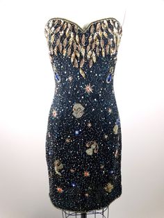 "An AMAZING dress fully embellished with sequins and beads all over in abstract astrology designs. It's in perfect condition! Measurements: Bust - 34/36\" Waist - 28/30\" Hips - 36/38\" Dress Length - 32\" This dress comes from a pet-free and smoke-free home. If you would like more info or have any questions, please don't hesitate to ask!" Space Themed Dress, Astrology Dress, Stars In Space, Junk Kouture, Gold Beaded Dress, Bday Dress, Sparkly Party Dress, Space Dress, Embroidery Dresses