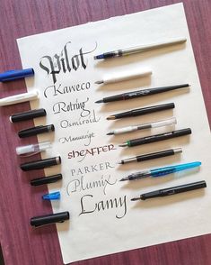 several pens are lined up on top of a piece of paper that has writing on it