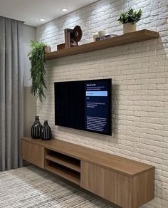 a flat screen tv sitting on top of a wooden entertainment center