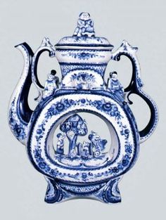 an ornate blue and white vase with figures on it