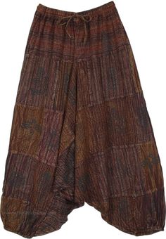 A smart pair of Aladdin style drop crotch pants that transport you back in time, these stonewashed effect loose pants are unique. With their patchwork style brown monochromatic pieces together, the pants have a traditional set of motifs on top which highlights the backdrop. #tlb #SplitSkirtsPants #Patchwork #bohemianfashion #Handmade #AladdinPants #DropCrotchpants #HaremPants #UnisexPants Bohemian Brown Wide Leg Harem Pants, Brown Patchwork Wide Leg Bottoms, Hippie Brown Harem Bottoms, Hippie Style Wide Leg Brown Bottoms, Brown Wide Leg Hippie Bottoms, Brown Wide Leg Festival Bottoms, Brown Wide Leg Bottoms For Festivals, Wide Leg Brown Bottoms For Festival, Hippie Style Brown Harem Pants For Festival