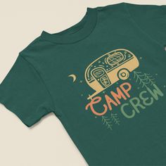 "Introducing our Kids' Camp Crew T-shirt, a delightful addition to your little one's outdoor wardrobe. This shirt showcases a charming camper and nature-inspired design with the words \"Camp Crew,\" perfect for young adventurers. Our T-shirt features a colorful illustration of a camper nestled among the trees and surrounded by the beauty of nature. The earthy tones and vibrant details capture the essence of outdoor exploration, making it the ideal choice for young nature enthusiasts. Searching for a thoughtful gift for a young adventurer? Our Camp Crew T-shirt is an excellent choice. It's perfect for birthdays, camping trips, or simply to inspire a love for the great outdoors." Cotton T-shirt With Funny Print For Outdoor Activities, Green T-shirt For Outdoor Activities, Green Graphic Print T-shirt For Camping, Green Crew Neck Top For Camping, Pre-shrunk Green T-shirt For Camping, Green Printed T-shirt For Outdoor Activities, Outdoor Funny Print Crew Neck Tops, Funny Print T-shirt For Outdoor Activities, Funny Print Crew Neck Top For Outdoor