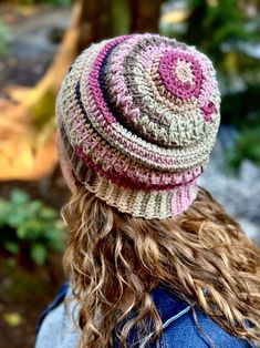 a woman with long hair wearing a knitted hat