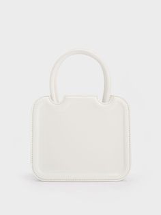 In classic white to match most outfits you can put together, the Perline sculptural tote bag is a worthy addition to your list of style staples. Featuring a square silhouette with rounded corners for a more feminine feel, the details make all the difference when it comes to this piece – the semicircle cut outs and gold-toned brand insignia add a touch of sophistication. Carry yours by the handles for a polished and sophisticated feel, or clip on the adjustable strap to create a cool and casual a Trendy White Box Bag For Daily Use, White Box Bag With Double Handle, Trendy White Square Box Bag, White Box Bag With Adjustable Strap For Daily Use, White Top Handle Box Bag With Adjustable Handle, White Shoulder Box Bag With Adjustable Handle, White Bag With Adjustable Handle For Daily Use, White Rectangular Bag With Top Carry Handle, White Tote Box Bag With Adjustable Handle