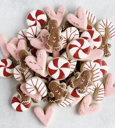 a pile of valentine's day cookies with hearts and gingerbreads on them