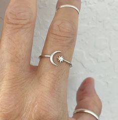 Sterling Silver Delicate Crescent Moon and Twinkle Star Ring, Dainty Ring, Sky Ring, Boho Ring, Silver Ring, Moon Ring, Star Ring, 925 Stamped Face Height: 8 mm Material: 925 Sterling Silver Finish: Polished We believe in delivering the same product which we are offering in the listing. PAYMENT POLICY WE ACCEPT THE PAYMENT THROUGH PAYPAL ONLY. SHIPPING POLICY YOU WILL RECEIVE SHIPMENT WITHIN 10 TO 15 BUSINESS DAYS AFTER RECEIVING THE PAYMENT VIA STANDARD NORMAL SHIPPING. WE ALSO PROVIDE PRIORITY Celestial Silver Star Midi Rings, Minimalist White Gold Star-shaped Ring, Celestial Star-shaped Midi Rings As Gift, Adjustable Star-shaped Midi Rings, Silver Star-shaped Celestial Midi Rings, Silver Star-shaped Ring With Gemstone, Symbolic Silver Star-shaped Ring, Sterling Silver Star-shaped Rings, Silver Moon-shaped Symbolic Ring