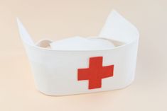 a white container with a red cross on it