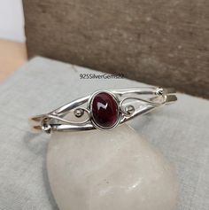 Welcome to our shop 925SilverGems22 Description:-  Style:- Bangle Advantages of Garnet Bangle:- It protects the wearer from negativity and evil thoughts. It induces passion, fire, energy, and stability, and is believed to bring good luck in love and relationships. Garnet is a stone meant to bring success in life and helps to achieve the goals set in life by its possessor. Occasion:- Anniversary Gift, Birthday Gift, Wedding Gift, Gift Bangle, Valentine's Gift, Engagement Gift, New Year Gift, Chri Sterling Silver Gemstone Bangle For Anniversary, Classic Sterling Silver Birthstone Bracelets, Classic Silver Bracelets With Birthstone, Classic Silver Birthstone Bracelets, Classic Silver Bracelet With Birthstone, Sterling Silver 925 Stamped Bracelets For Anniversary, Sterling Silver Birthstone Bracelet For Anniversary, Silver Spiritual Birthstone Bracelets, Hallmarked Oval Bangle For Gift