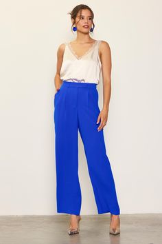 Wide-leg trousers are a staple in any season, but the pop color makes this pair especially fun. These tailored pants sit high on the waist, designed with an extended waist tab, a pleated front, and streamlined pockets. An elasticized back waistband makes for an extra-comfortable fit. •Long Pants •Elasticized waist •Double-tiered pleat •Laser-cut hems Item Number: 74266 Bright Blue Trousers Outfit, Chic Solid Color Tapered Leg Bottoms, High Waist Blue Wide Leg Pants For Business Casual, Blue Wide Leg Pants With Pockets For Work, Chic Tapered Leg Dress Pants With Pockets, Chic Tapered Leg Pants With Pockets, Chic Dress Pants With Tapered Leg And Pockets, Chic Blue Wide Leg Pants For Business Casual, Blue High-waisted Wide Leg Pants For Business Casual