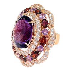 Cluster Multi Color Fancy Gems from Sri Lanka Purple Amethyst - 9 Carat White Topaz - 2 Carat Red Garnet - 3 Carat  This Ring is from the  “Flamenco”  traveling collection are the epitome of elegance and versatility. It offers a perfect blend of day to night and swimwear to evening wear, allowing you to effortlessly transition between different occasions and outfits. Wearing these spectacular oriental-style ring will undoubtedly make you the center of attention. It adds a touch of glamour and sophistication to your favorite caftans, swimwear, or evening attire, enhancing your overall look. The  “Flamenco”  collection, from which this ring originates, showcases exceptional craftsmanship and incorporates natural gemstones. The ring is set in 18k gold and silver, guaranteeing its quality and Multi Gem Ring, Fancy Sapphire, Tree Jewelry, Tanzanite Diamond Ring, Garnet And Gold, Topaz Color, Gold Cocktail Ring, Gold Cocktail, Jewelry Tree