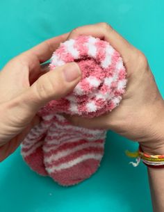 a person is holding a pink and white object