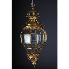 an ornately decorated light fixture hanging from the ceiling in front of a black background