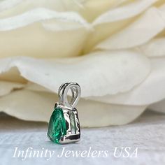 "The pendant pictured is a lab created emerald #6074 -Approximate total carat weight: approx. 1.80ctw diamond equivalent -Center Stone Size: 7x7mm - approx. 1.80ct diamond equivalent -Center Stone Shape: trillion -Gem Type: lab created emerald -Stone Clarity: VS2 -Stone Color: green -Moh's Scale: 8.5 hardness -Metal Type and Purity: 14k white gold -Setting: 3 prong basket head open back design -Chain: delicate 14k gold chain / heavier option with lobster claw available (use dropdown to select) - Gift Emerald Necklace With Brilliant And Emerald Cuts, Gift Pear-shaped Brilliant Cut Emerald Necklace, Pear-shaped Brilliant Cut Emerald Necklace Gift, Sterling Silver Brilliant Cut Emerald Necklace Gift, Fine Jewelry Emerald Teardrop Pendant Necklace For Anniversary, Fine Jewelry Teardrop Pendant Emerald Necklace For Anniversary, Teardrop Emerald Jewelry With Brilliant Cut, Pear-shaped Emerald Gemstone Necklace, Anniversary Brilliant Cut Emerald Necklace In Sterling Silver