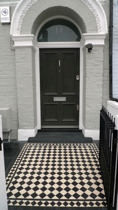 a black and white checkered floor in front of a door