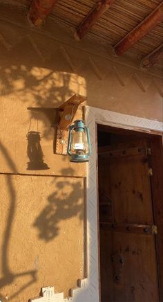 a light that is on the side of a building next to a door and window