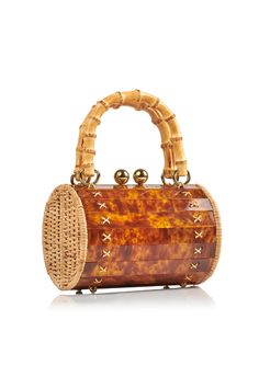 Meet the Alix Bambu Turtle Bag, a versatile and stylish addition to your accessory collection. Featuring a charming bamboo handle and a removable leather shoulder strap, this bag seamlessly transforms from a shoulder bag to a crossbody or handbag. It is a unique blend of handwoven, natural rattan and modern acrylic, which creates a playful yet sophisticated look. Perfect for any occasion, this bag is your go-to for effortless style and functionality. Luxury Brown Bag With Bamboo Handle, Luxury Brown Bags With Bamboo Handle, Luxury Crossbody Bag With Bamboo Handle, Brown Crossbody Shoulder Bag With Bamboo Handle, Elegant Natural Bucket Bag With Bamboo Handle, Luxury Satchel Shoulder Bag With Bamboo Handle, Luxury Rectangular Shoulder Bag With Bamboo Handle, Luxury Bucket Shoulder Bag With Bamboo Handle, Brown Top Handle Bag With Bamboo Handle