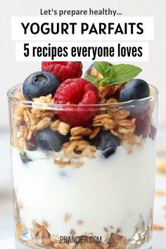 yogurt parfaits in a glass with berries and granola on top