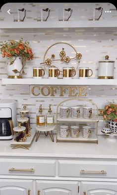 a coffee bar with gold accents and white cabinets