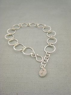 This sterling silver hammered link bracelet is lightweight and comfortable enough for everyday wear.I have made each link of this bracelet by hand from sterling silver wire, each link has been soldered closed so the bracelet is sturdy.  The hoop links have been hammered to give it a slight texture ans ever so slightly flatten the links.  The bracelet is finished with a high shine polish which allows it to catch the light.  It is an elegent additional to your jewellery collection.Length:  7.5 inc Double Finger Ring, Silver Link Bracelet, Chain Bracelets, Bracelet Chain, Chain Links, Silver Jewelry Rings, Hammered Silver, Sterling Silver Hoops, Jewellery Collection