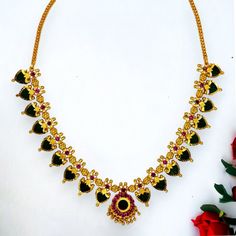 Gold Plated Kerala Traditional Palakka Necklace is Simple and ethnic South Indian, Kerala Jewellery. This Jewelry has been arranged beautifully with Palakka and stones. Small round Pendant has golden bead hangings. Length can be adjusted with the backlink chain. It is best suited on festive occasions, Marriages and as Bridal wear and dancewear. Kerala Jewellery, Necklace Online, Round Pendant, Fashion Jewellery, Bridal Wear