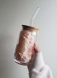 a person holding a glass jar with a straw in it that says, i am amazing