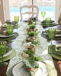 the table is set with green and white dishes