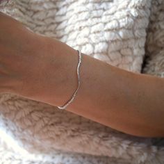 For these bracelets, I used round sterling silver beads strung on stretchy, durable beading cord for effortless wear. The slim, diamond-cut wavy tube adds extra sparkle and elegance to the design. I love wearing this bracelet stacked with my other favorites, also perfect on its own for a chic and simple look. ✨ Details ✨ 📍Diamond-cut wavy bar measures 30☓2mm 📍Sterling silver round ball measures 2mm 📍Handcrafted Jewelry Made just for you  ✔︎ Nickel Free  ✔︎ Hypoallergenic ❥  Please ENSURE your SHIPPING ADDRESS before check out! ❥ All orders ship nicely gift wrapped, perfectly ready to treat yourself or a special someone. ❥ If you have any questions, please contact me vis Etsy convo XOXO Bracelet Layering, Beading Cord, Curved Bar, Bracelet Diamond, Bar Bracelet, Ball Bracelet, Bar Bracelets, Layered Bracelets, Bead Stringing