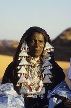 an old woman in traditional dress with jewelry on her neck