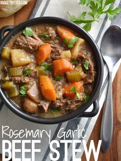 a bowl of stew with carrots, celery and potatoes on a table