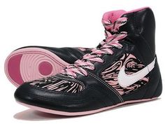 a pair of black and pink high top sneakers