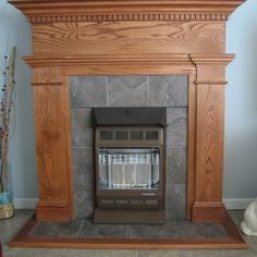 a fireplace with a stone hearth and wooden mantle