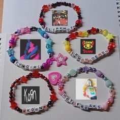 several different bracelets with pictures and words attached to them on a sheet of paper