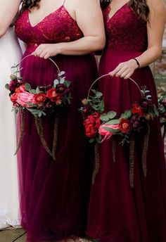 three bridesmaids in burgundy dresses with flower crowns