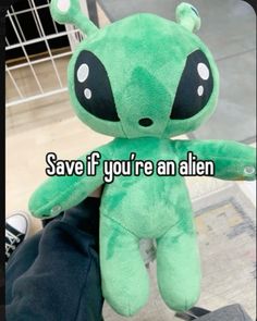 a green stuffed animal with the words save if you're an alien